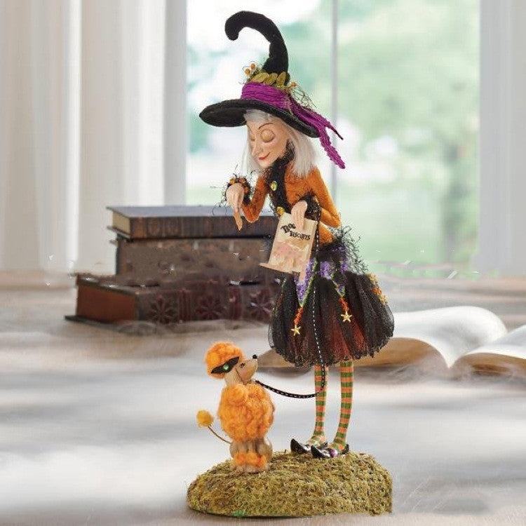 Decorative witch figurine with a dog on a windowsill