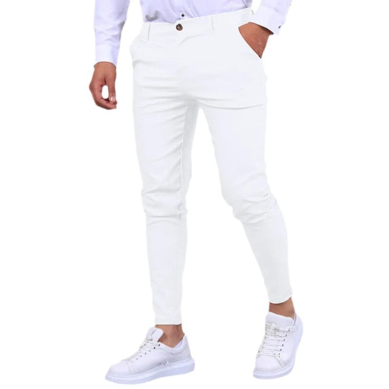 Person wearing white jeans and white sneakers on a white background