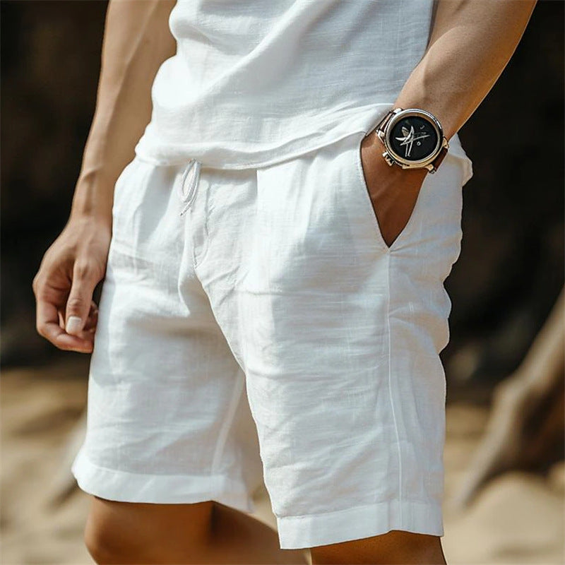 Person wearing white shorts and a watch with a blurred background