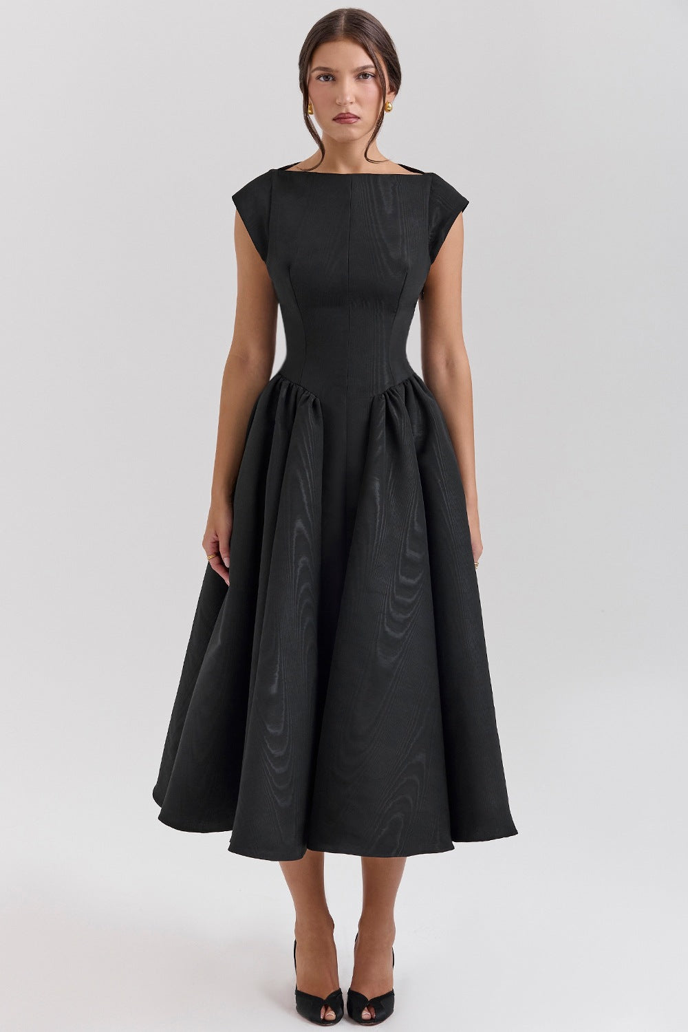 Woman wearing a black dress on a white background