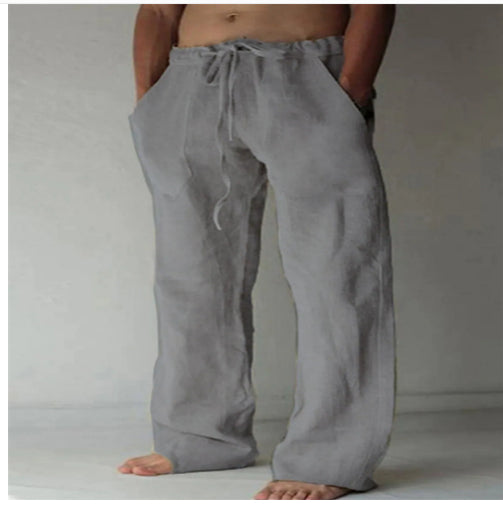 Person wearing gray wide-leg pants against a plain background