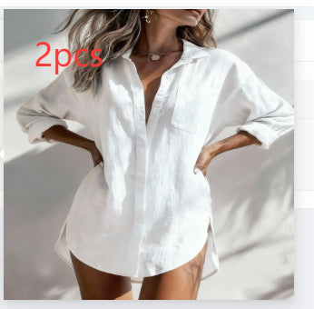 A woman wearing a loose white button-up shirt with rolled sleeves and side slits, shown from the shoulders to mid-thigh. The photo has a warm, filtered look with soft shadows, and the text '2pcs' appears in red near the upper left.