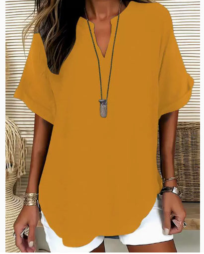 Person wearing a mustard yellow top with a neutral background