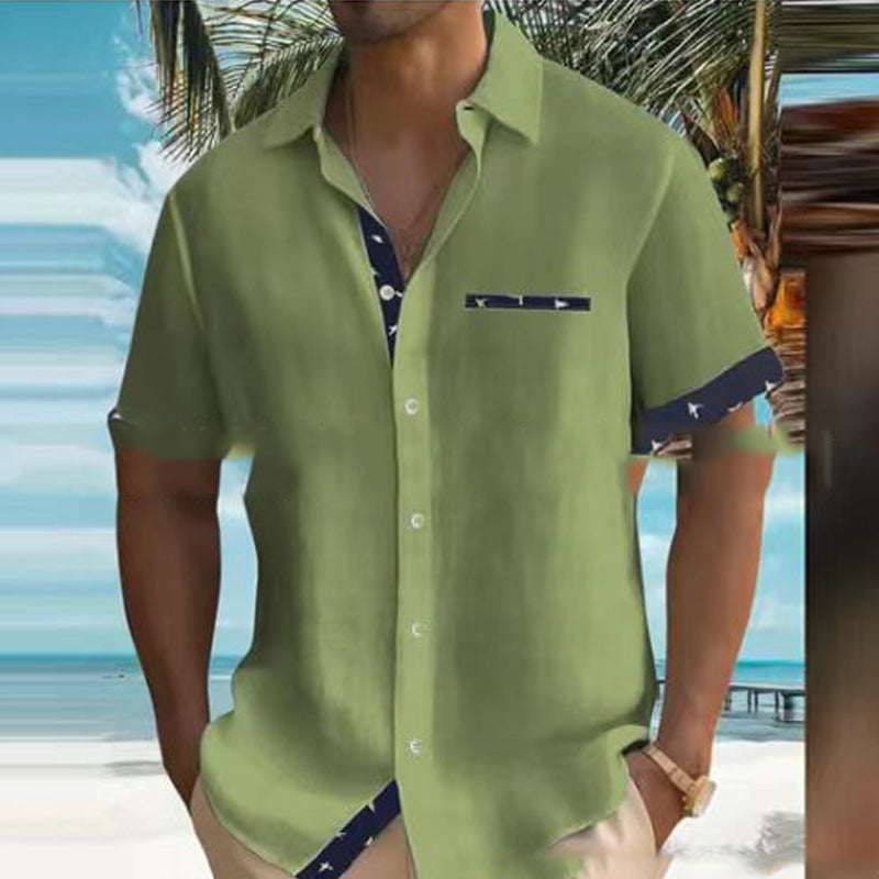 Person wearing a green shirt with a beach background