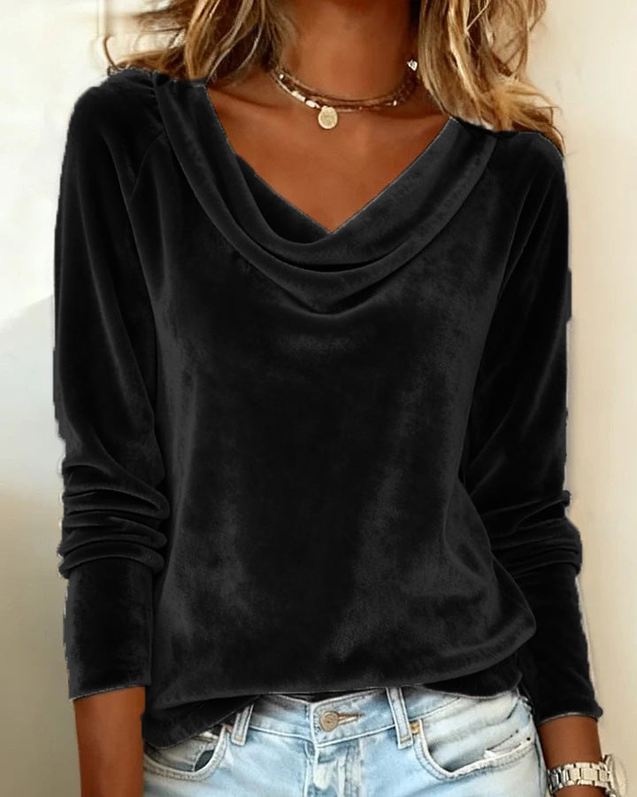 Black long-sleeve top worn by a person with a neutral background