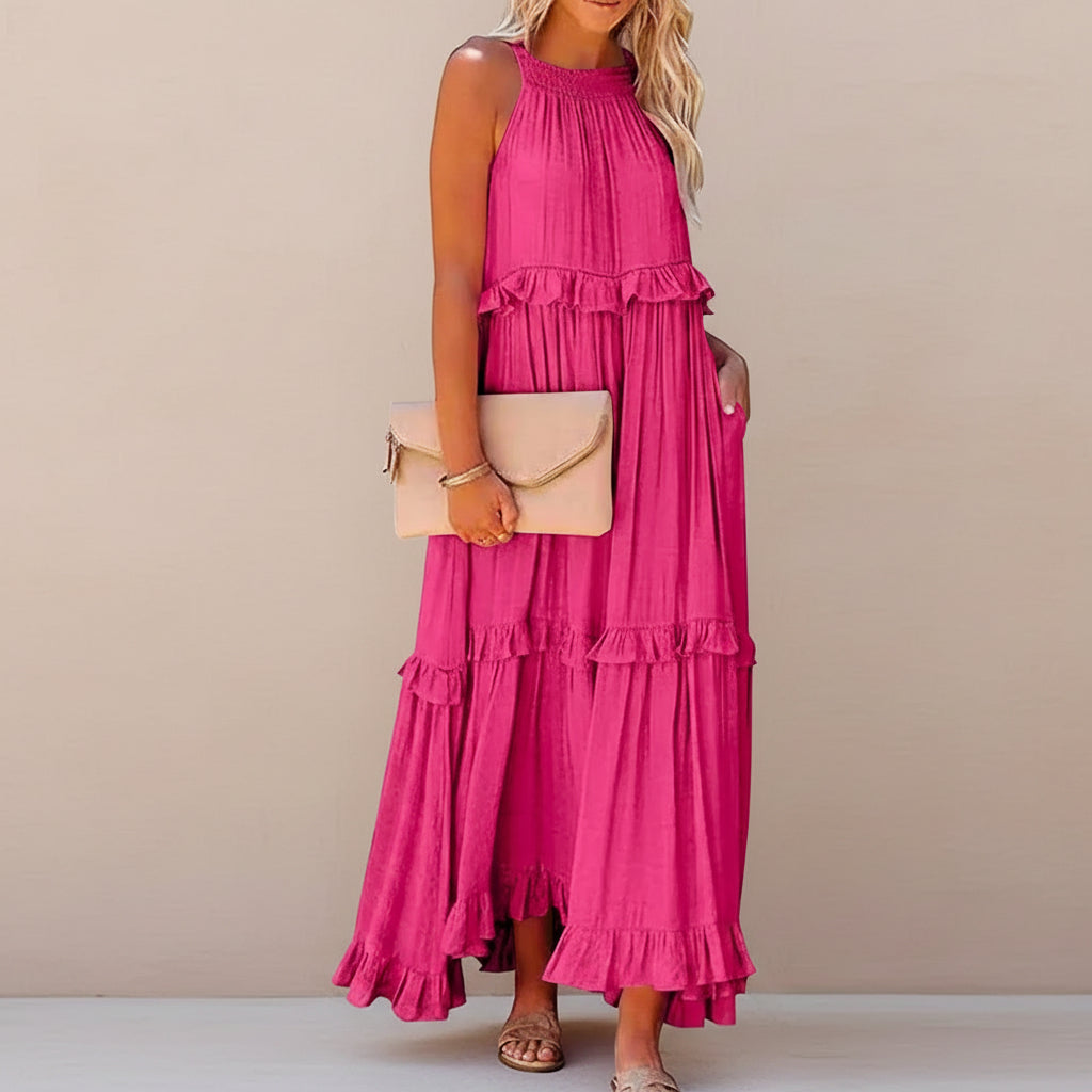 Woman wearing a pink ruffled dress with a beige handbag on a white background