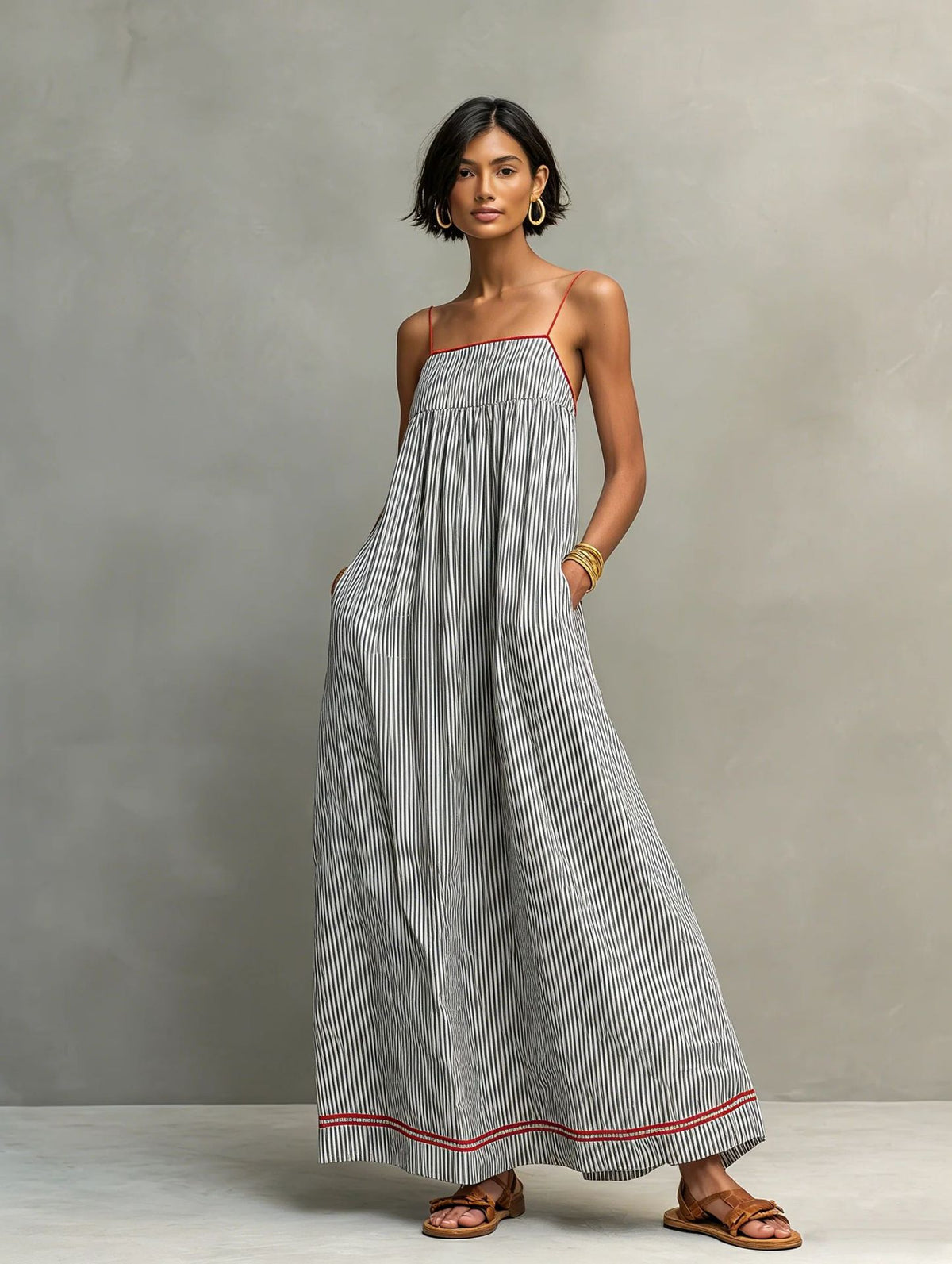 Woman wearing a striped dress with a plain background