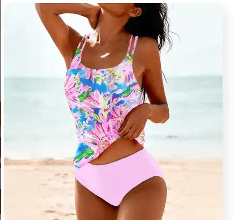 Woman wearing a colorful floral swimsuit on a beach