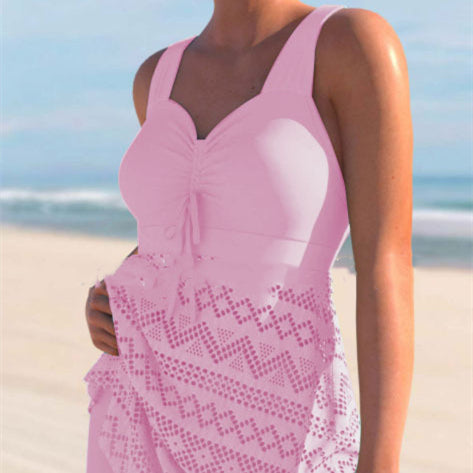 Person wearing a pink lace dress on a beach