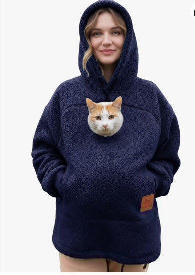 Person wearing a navy blue hoodie with a cat face design on a white background