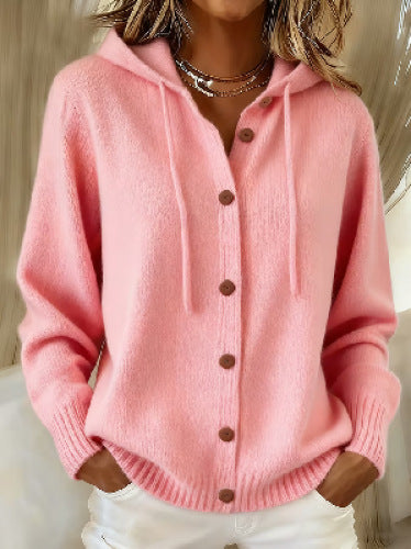 Pink cardigan with brown buttons worn by a person