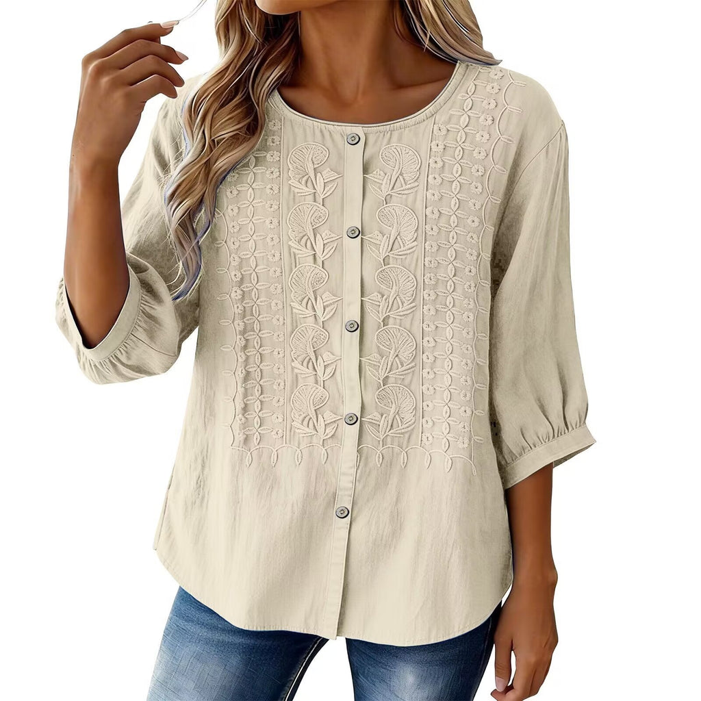 Beige blouse with lace details worn by a model on a white background