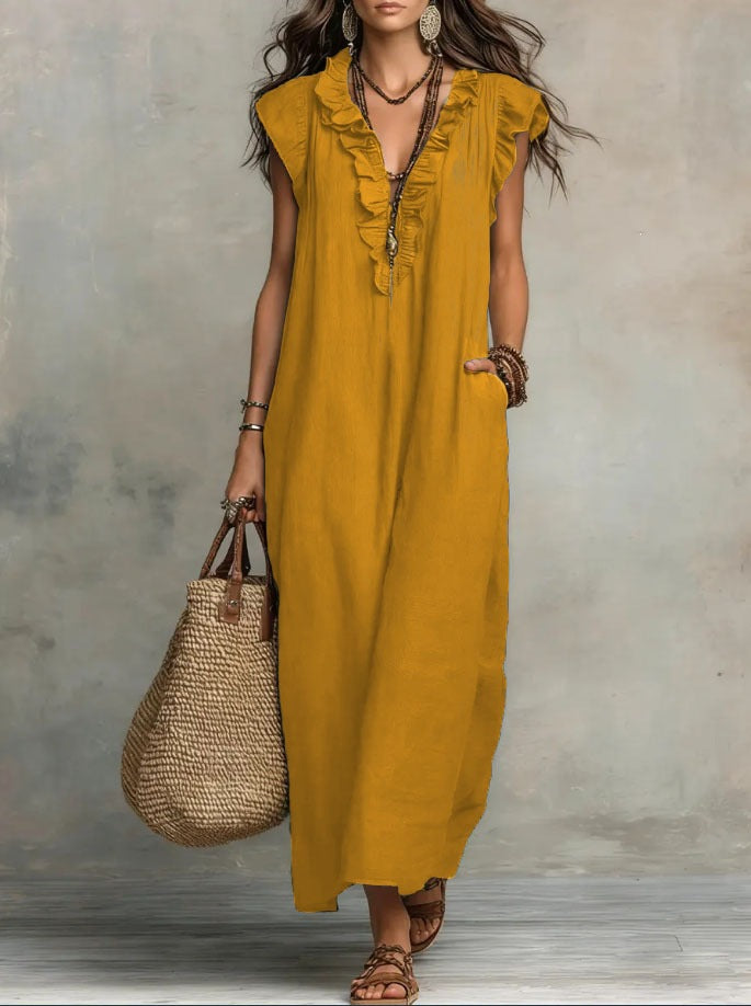 Woman wearing a yellow dress holding a woven bag against a neutral background