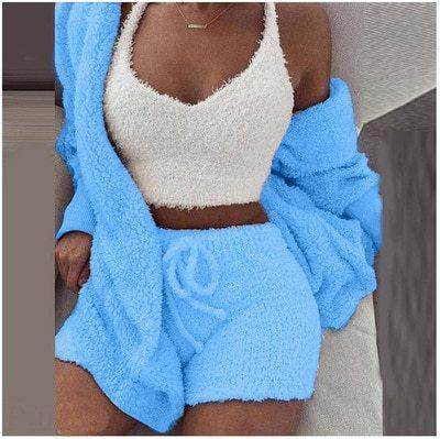 Woman wearing a fuzzy white crop top with matching blue shorts and cardigan, ZA-Zola loungewear