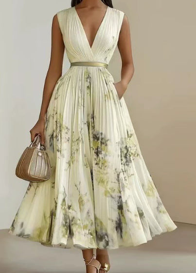 Woman wearing a floral dress holding a handbag against a neutral background