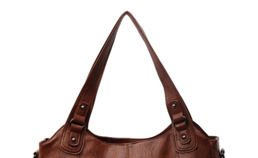Brown leather handbag on a white background