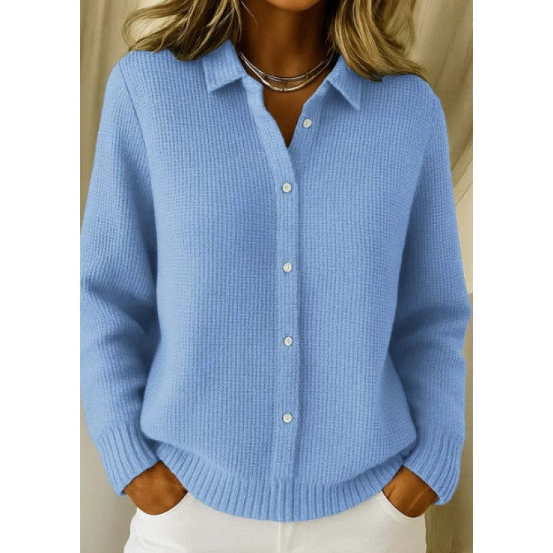 Blue button-up sweater worn by a person on a plain background