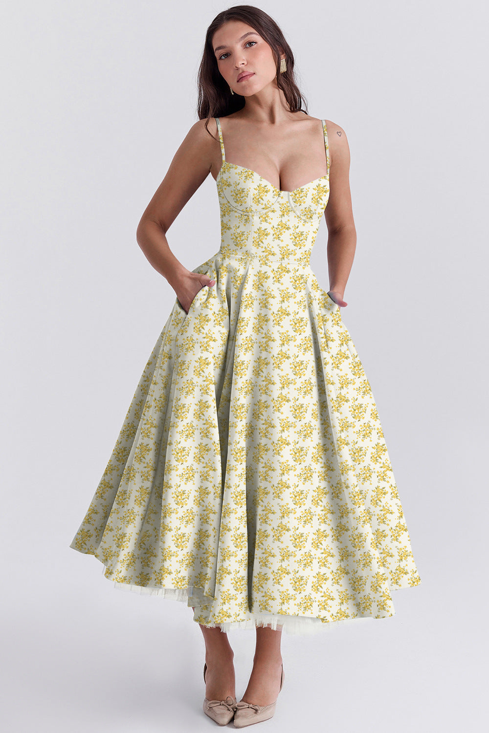 Woman wearing a yellow floral dress on a white background