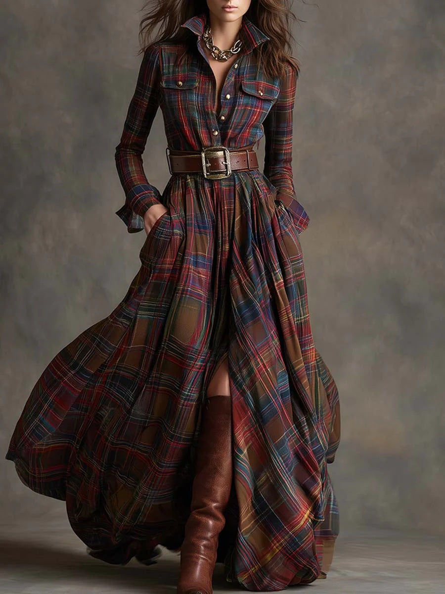 A woman models a long-sleeve plaid shirt dress with a high-low hem, worn with a brown belt and brown leather knee-high boots against a textured gray studio backdrop.