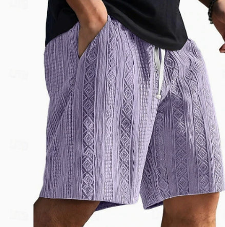 Person wearing purple patterned shorts on a white background
