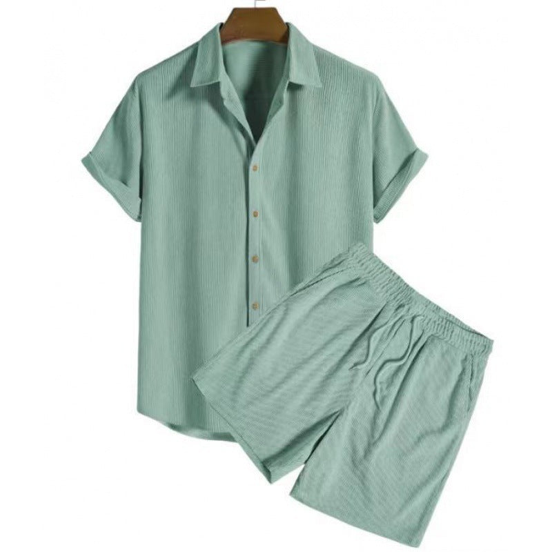 Light green pajama set on a hanger against a white background