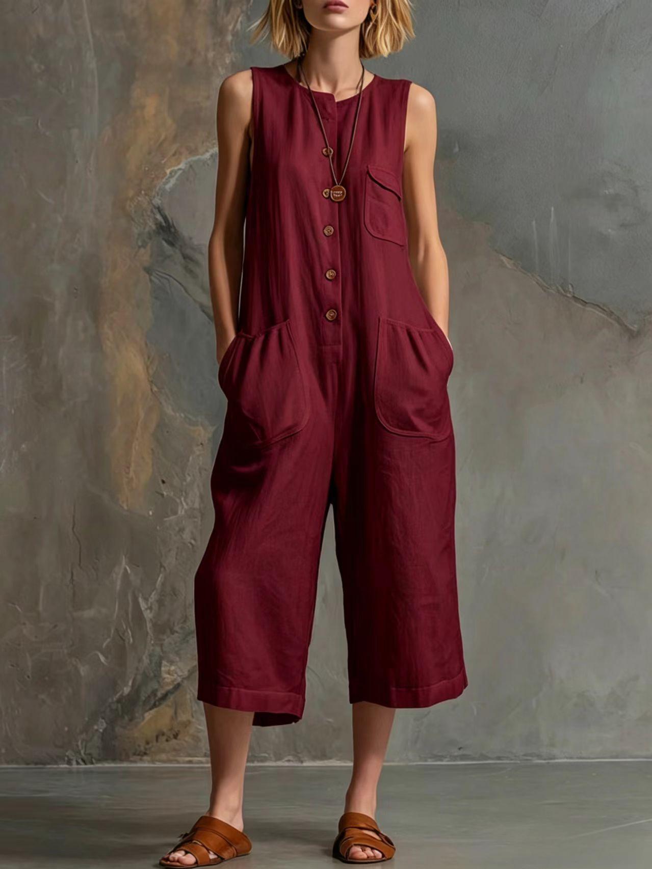 Person wearing a burgundy jumpsuit against a textured wall.