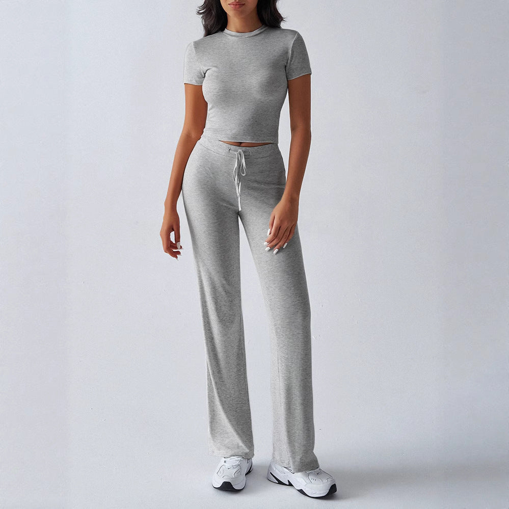 Person wearing a gray knit two-piece set on a white background