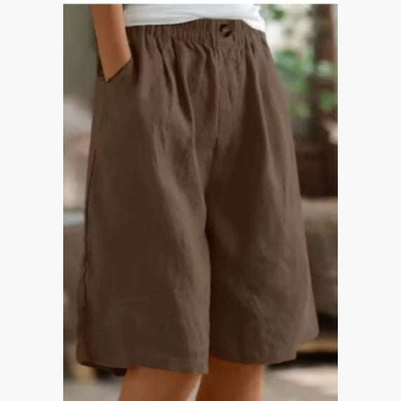 Brown shorts worn by a person with a blurred background