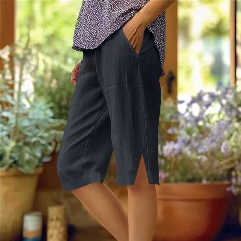 Person wearing dark shorts with a blurred garden background