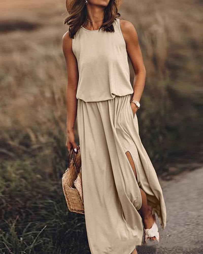 Woman wearing a beige sleeveless top and long skirt in a natural setting