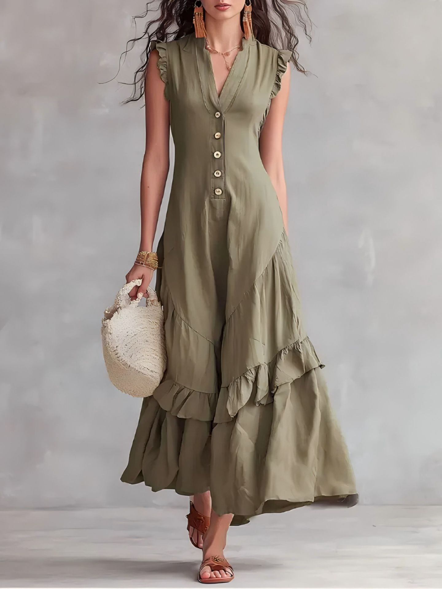 Woman wearing a green dress with ruffled layers against a plain background