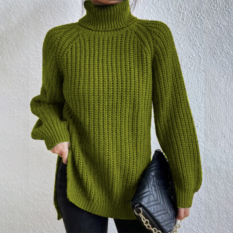 Person wearing a green knitted sweater against a white background