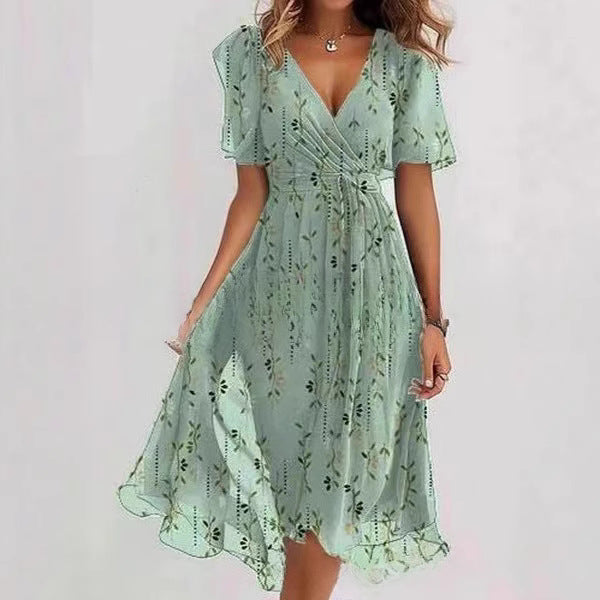 Woman wearing a light green floral dress on a white background