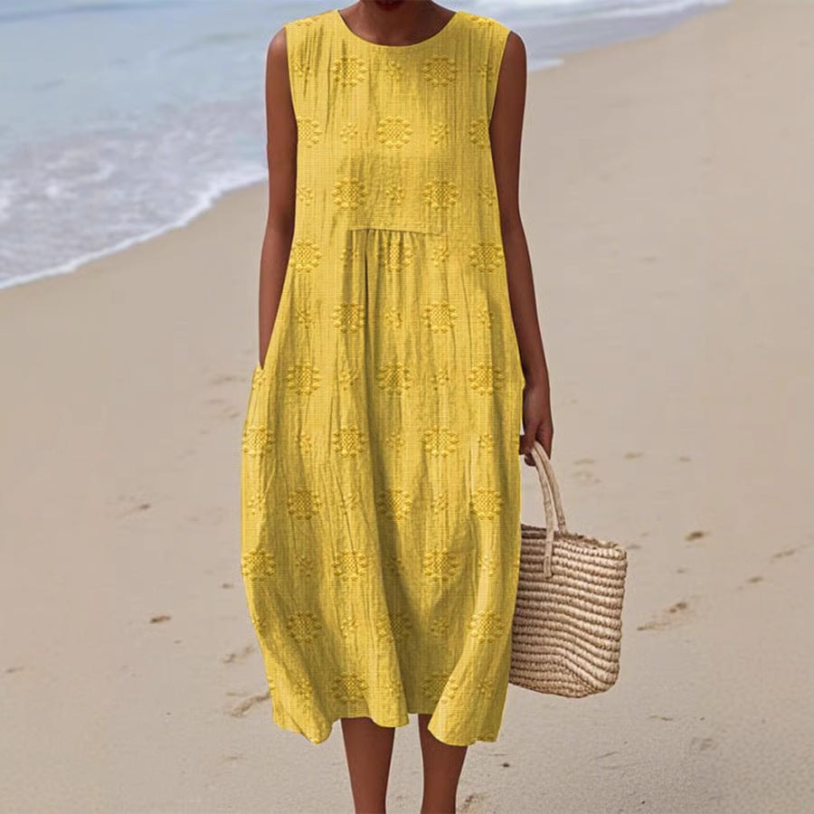 Woman in a yellow dress holding a straw bag on a beach