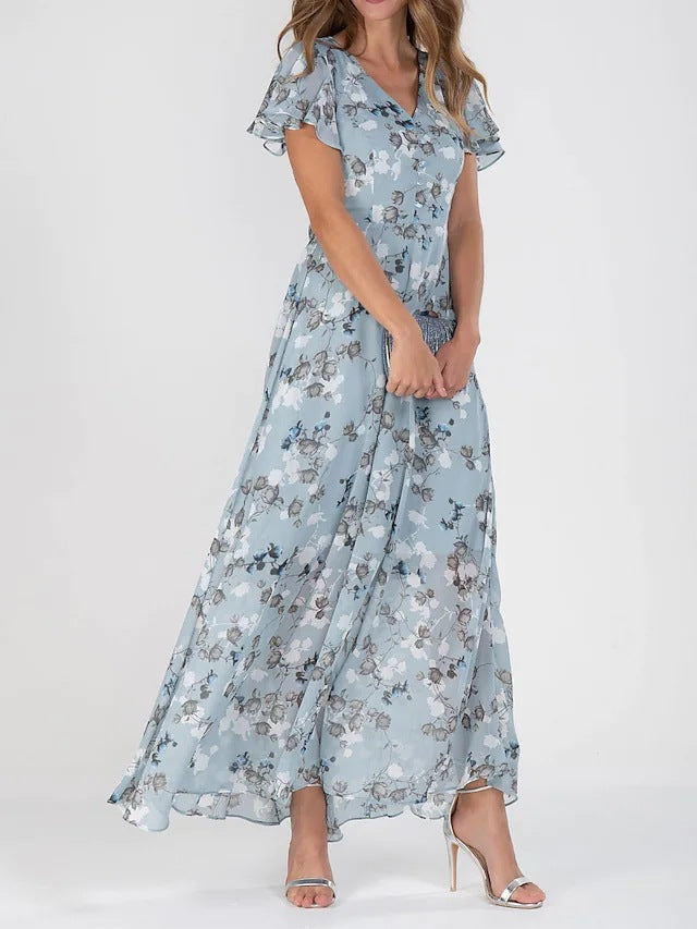 Woman wearing a light blue floral dress on a white background