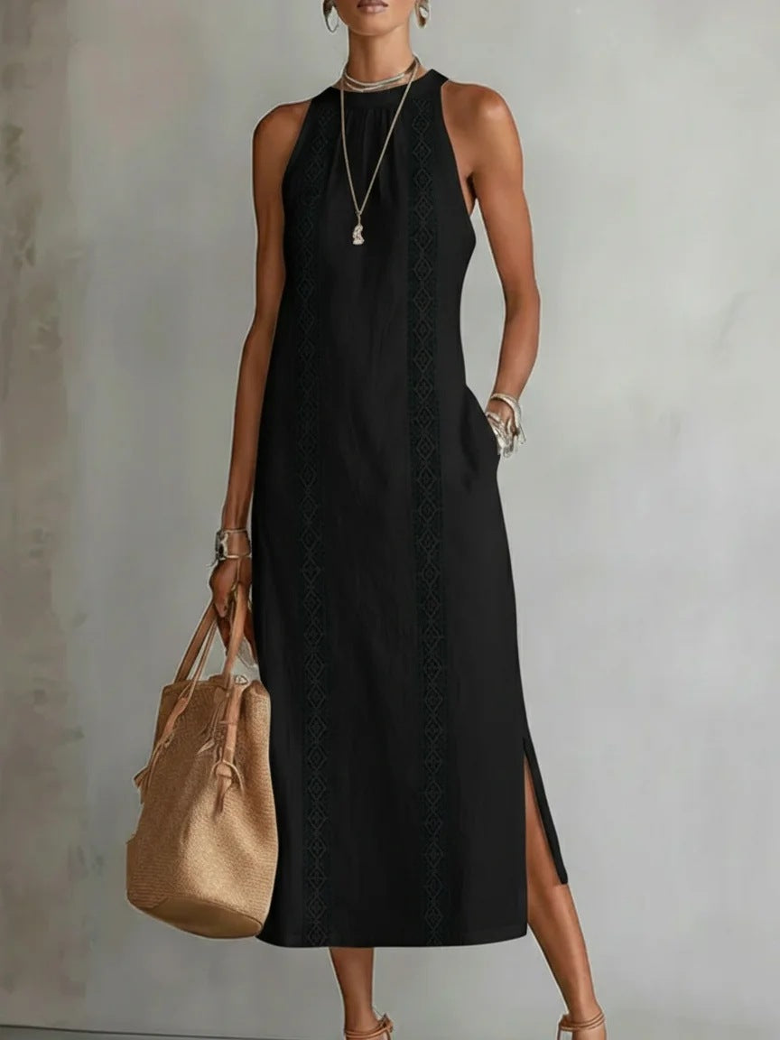 Woman wearing a black dress holding a beige bag against a plain background