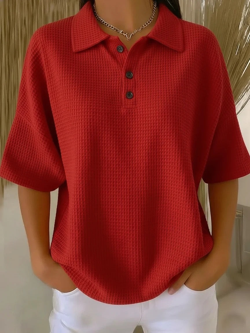 Red textured polo shirt worn by a person with a neutral background