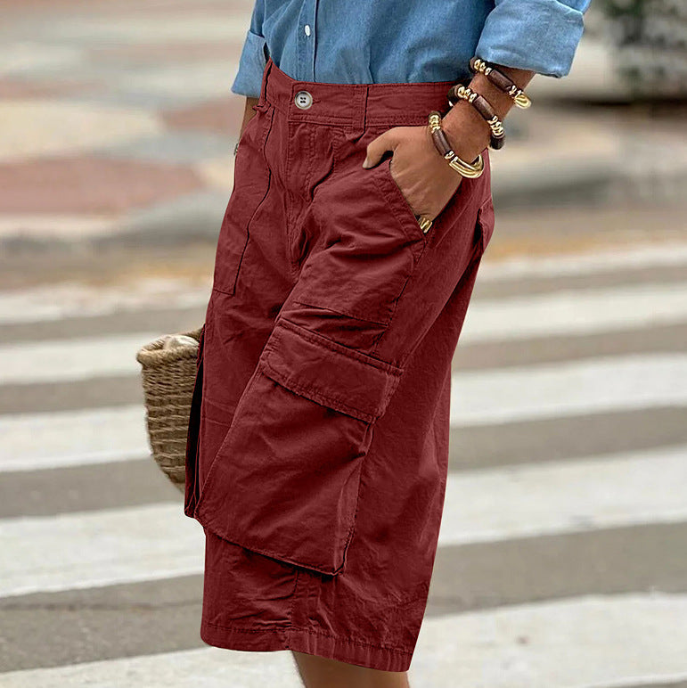 Person wearing red cargo shorts with a blurred background