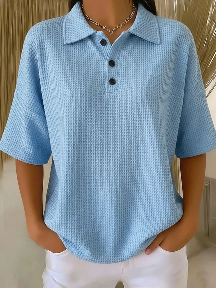 Light blue textured polo shirt worn by a person with a neutral background