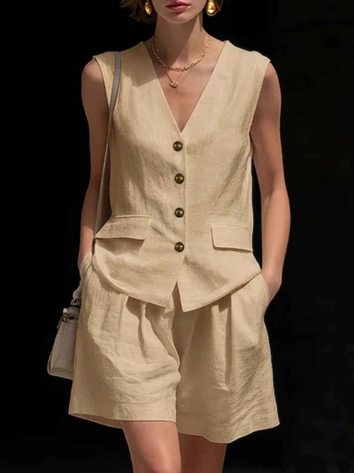 Woman wearing a beige sleeveless top and shorts set with a black background