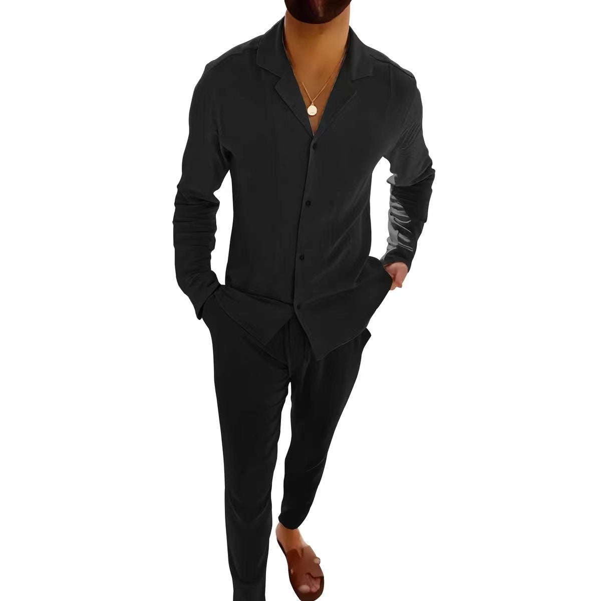 Person wearing a black button-up shirt and pants on a white background