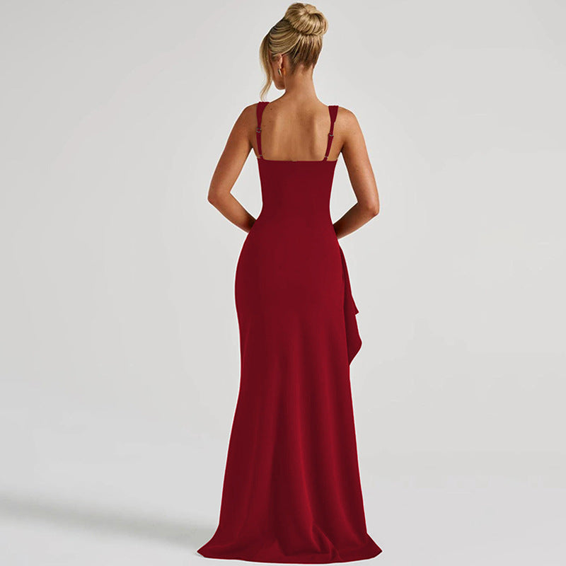 Woman wearing a red evening gown on a plain background