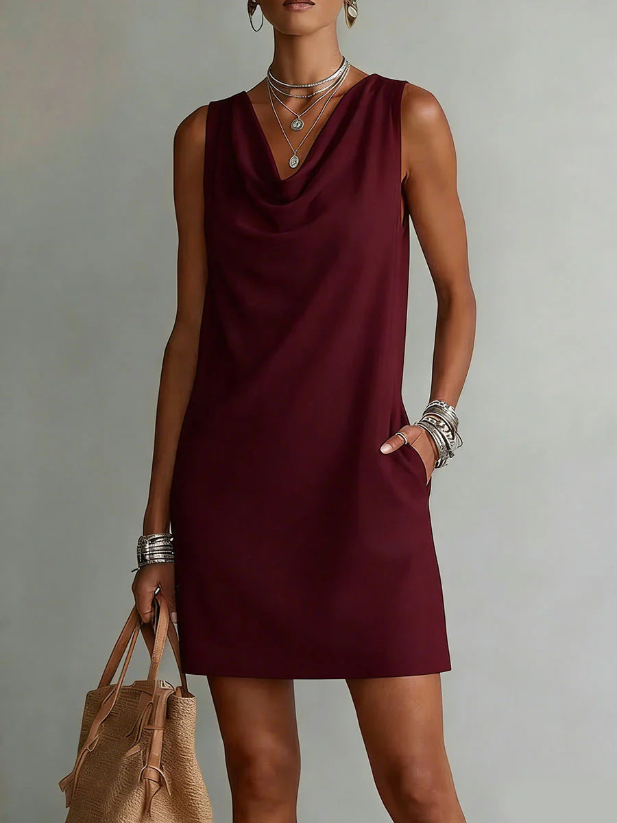 Woman wearing a burgundy dress with a neutral background