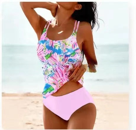 Woman wearing a colorful floral swimsuit on a beach