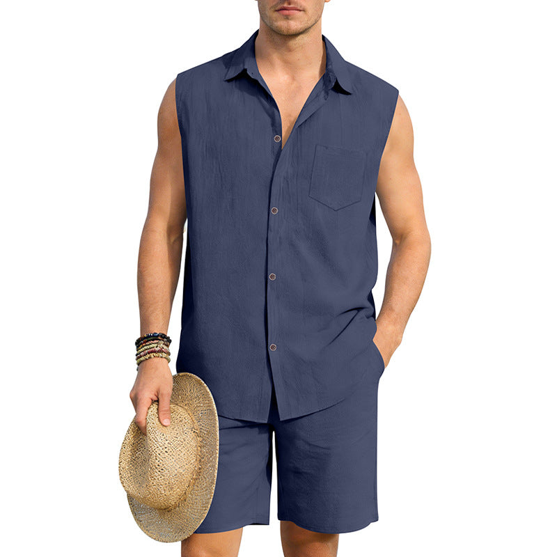 Man wearing a navy sleeveless shirt and shorts holding a straw hat on a white background