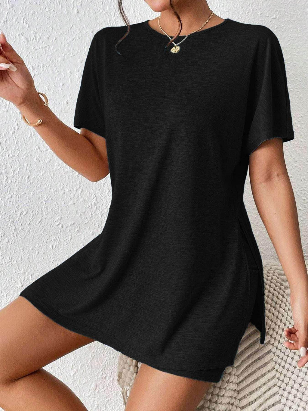 Woman wearing a trendy black t-shirt dress from ZA-Zola, chic casual fashion, UK style