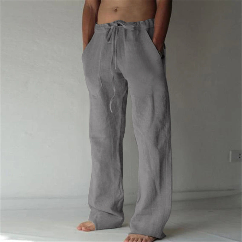 Person wearing gray drawstring pants against a plain background