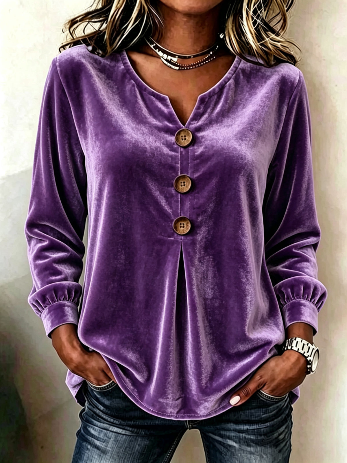 Purple velvet button-up shirt worn by a person against a neutral background
