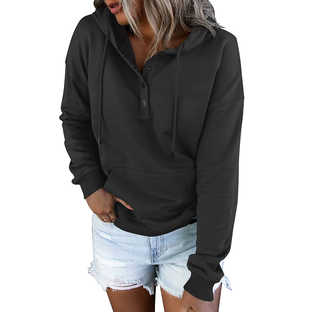 Person wearing a black hoodie and denim shorts on a white background