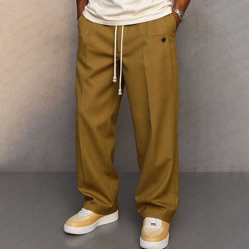 Person wearing mustard yellow pants with a plain background